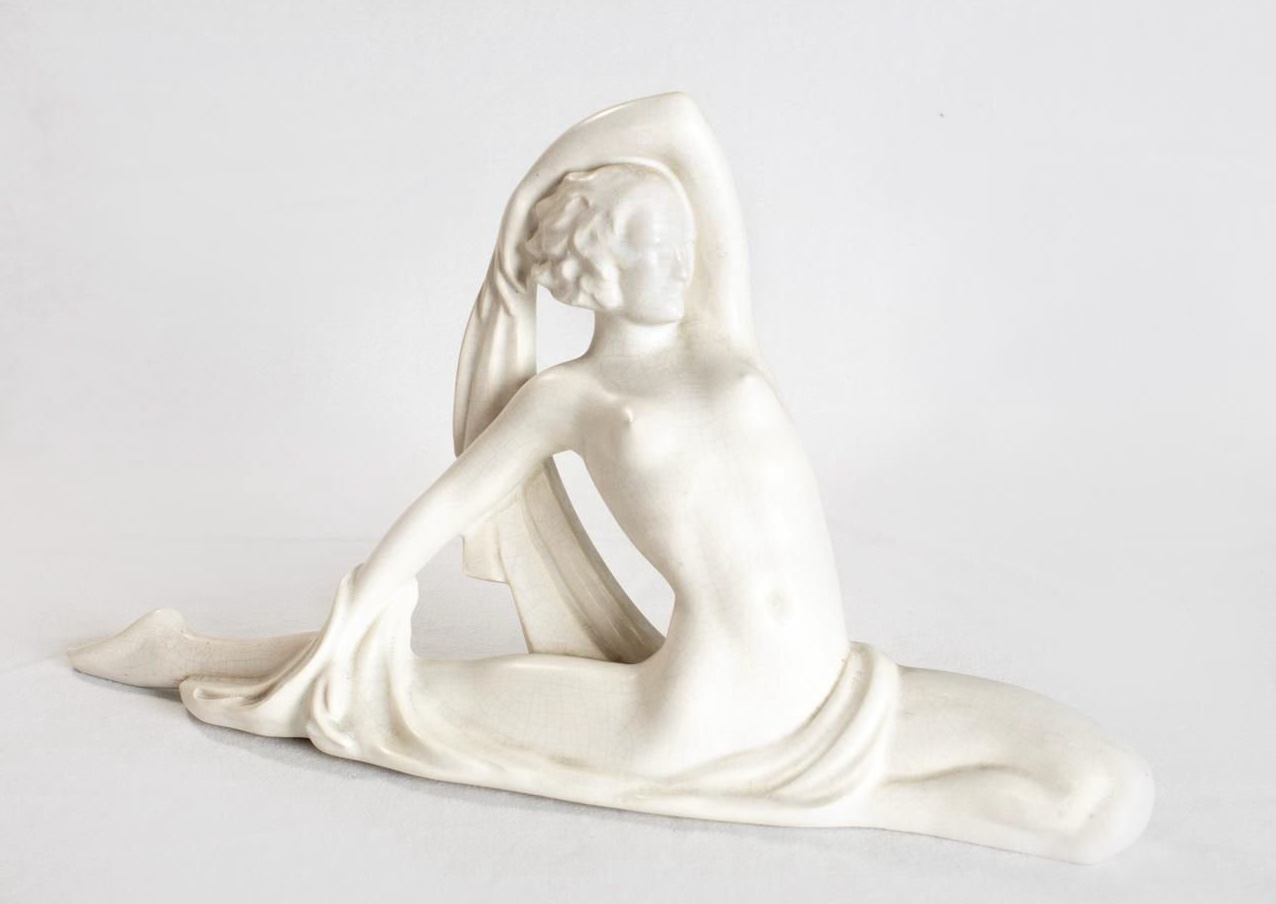 Statuette of a female dancer, carved between 1929 and 1939, a mantelpiece feature in white crackle-glazed ceramic.